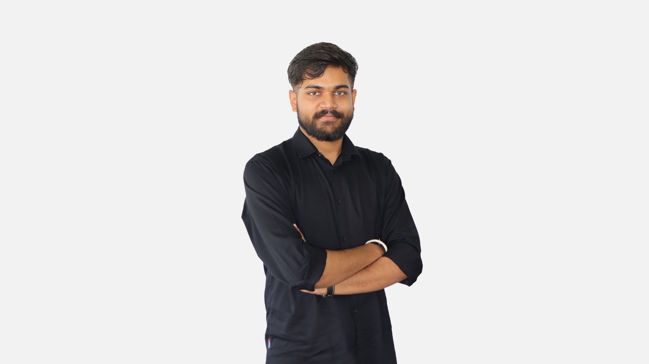 https://media.devpulse.info/A young man wearing black shirt folding his hands with a smiling face posing for a professional photo.