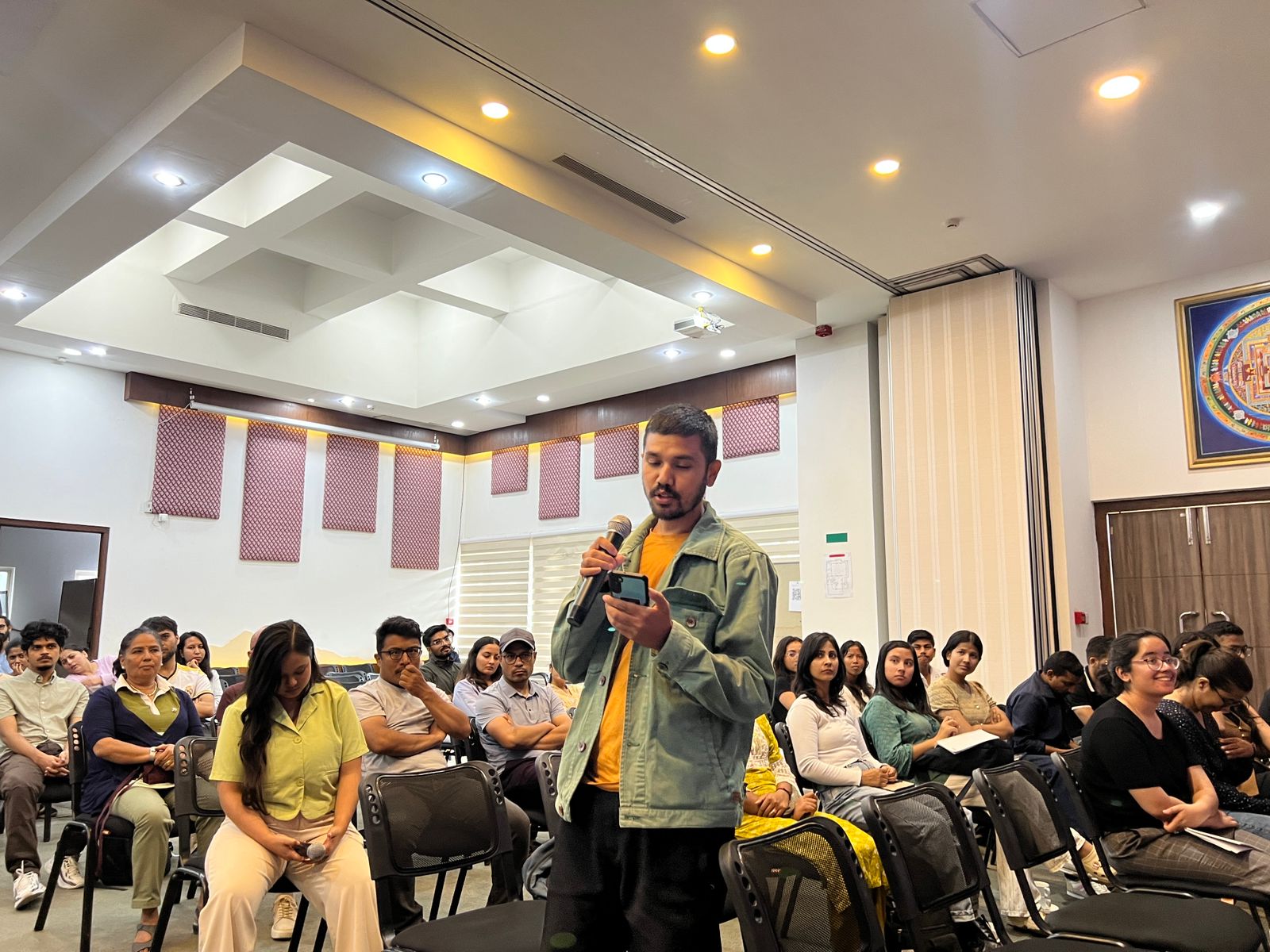 A participant stood up to share his reflections with the attentive audience during the Q&A session of the documentary screening at ICIMOD headquarters in Khumaltar.